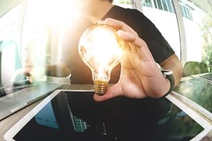 A doctor holds a lightbulb representing a bright idea